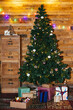 © BONNINSTUDIO/Stocksy - Christmas tree and presents against wooden wall