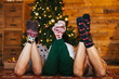 © BONNINSTUDIO/Stocksy - Crop women in socks resting near Christmas tree
