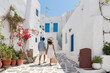© Hernandez & Sorokina/Stocksy - Anonymous Couple Having A Walk In Greece, Paros Village