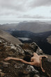 © Anastasia Mihaylova (Shpara)/Stocksy - Nude woman lying on her arm in front of black lava river in Iceland