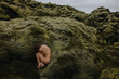 © Anastasia Mihaylova (Shpara)/Stocksy - Young slim woman in fetal position in the green moss in Iceland