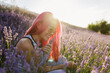 © VICTOR TORRES/Stocksy - Young woman smelling lavender flowers in field