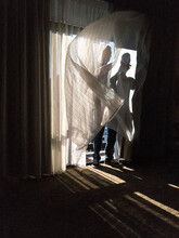Unrecognizable Man Caught In Sheer Curtains