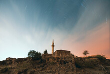 Long Exposure Photography, Star Trails Of An Old Stone Mosque With Colored North Sky And Clouds