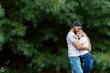 Young Engaged Man And Woman Hugging Each Other Outdoors