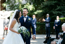A Bride And Groom Laugh And Smile After Their Wedding Ceremony
