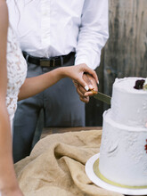 Close Up Of Hands During Cake Cutting At A Wedding