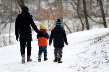 Family Walking In The Snow