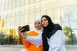 © Luis Velasco/Stocksy - Muslim Girls With Phone Taking A Selfie.