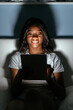 © David Prado/Stocksy - Smiling black woman with tablet