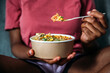 © David Prado/Stocksy - Unrecognizable woman eating poke bowl