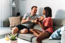 Content Diverse Couple Eating Poke Bowls At Home