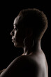 © Leonardo Borges/Stocksy - Portrait of an afro woman on black background
