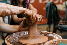 Unrecognizable People Creating Clay Vessel