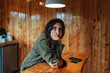 © Luis Herrera/Stocksy - sleepy woman looking at camera