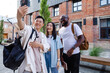 © Oleksii Syrotkin/Stocksy - Multiracial friends taking selfie on phone