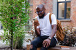 © Oleksii Syrotkin/Stocksy - Man using smartphone in free time