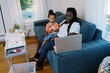 © Serena Burroughs/Stocksy - Woman working from home with her kids