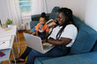© Serena Burroughs/Stocksy - Woman working from home with her kids