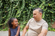 © Lupe Rodríguez/Stocksy - multiracial family of father and daughter in the park outdoors