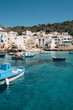 © Kirstin Mckee/Stocksy - Boats of different colours float in the blue waters of Levanzo harbour