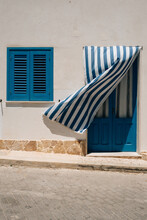 Curtain In Front Of Blue Door Billows In Wind, Marettimo. 