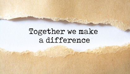 together we make a difference appearing behind torn paper. business concept