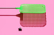 © Jeff Wasserman/Stocksy - Fly Swatter and Fly on Pink Surface