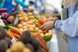 © Javier Pardina/Stocksy - Woman buying carrots in the farmer's market
