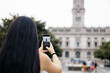 © Pedro Merino/Stocksy - Tourist taking photos with smartphone in Porto city