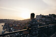 © Pedro Merino/Stocksy - Young man watching Porto city from the bridge