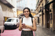© Pedro Merino/Stocksy - Young adult using smartphone in pink street
