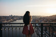 © Pedro Merino/Stocksy - Young woman watching Porto city from the bridge