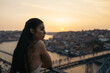 © Pedro Merino/Stocksy - Pretty young woman watching the sunset