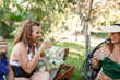 © Lupe Rodríguez/Stocksy - group of mature friends drinking lemonade in the garden of a house