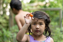 Little Girl With Tomato