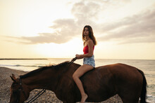 Girl Riding A Horse On An Empty Beach