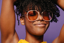 Cheerful black woman in trendy sunglasses