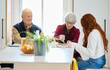 © Guille Faingold/Stocksy - Grandparents and granddaughter having breakfast