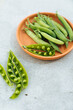 © Natalia Mishina/Stocksy - Green pea pods.