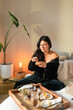 © ByLorena/Stocksy - Young woman having breakfast at bedroom