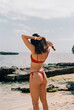 © Lucas Ottone/Stocksy - Unrecognizable woman in a red bikini
