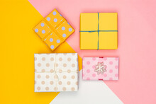 Pastel Presents Scatted Over Pink Background