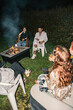 © Laura Herrera/Stocksy - Group of friends near the bonfire