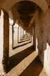 © Tania Cervian/Stocksy - Arched pathway outside old building