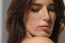 Closeup portrait of brunette woman in sunlight