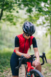 © Daniel Gonzalez/Stocksy - Tired female athlete resting during bike trip