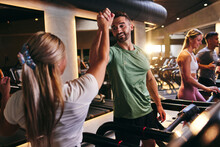 People High-fiving After A Treadmill Class