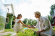© AD Astra Team/Stocksy - Mom and daughter are picking carrots in the garden