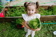 © AD Astra Team/Stocksy - Mom and daughter are picking cabbage in the garden